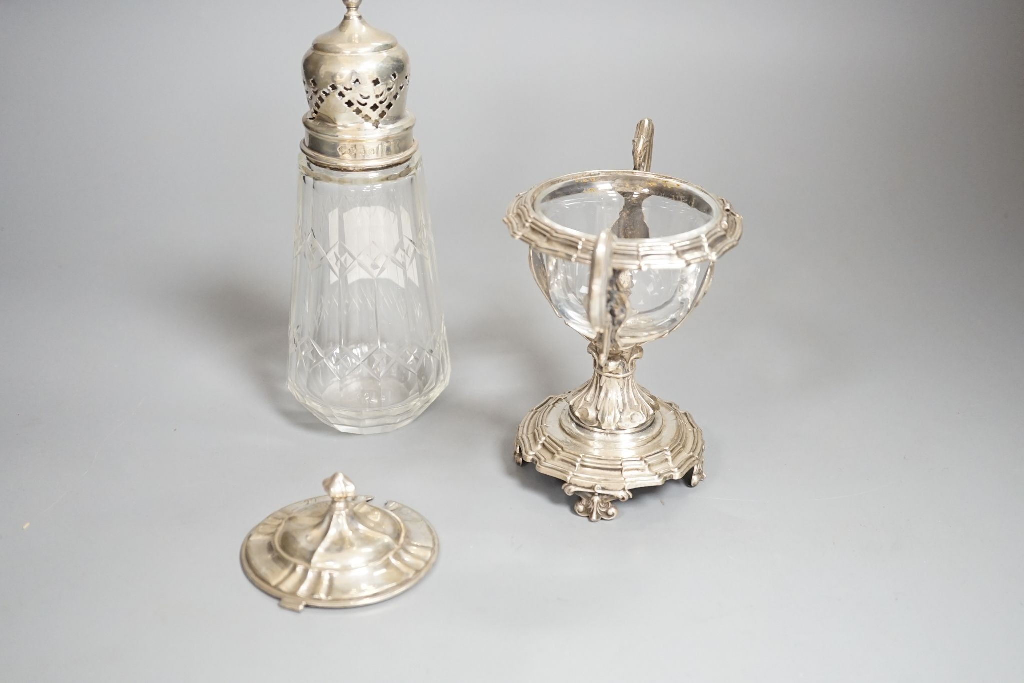 A George V silver mounted glass caster and a continental silver mustard pot frame (the latter a.f)